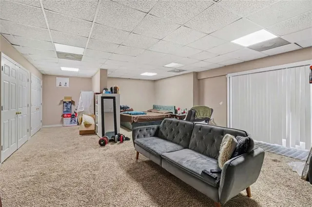 a living room with furniture and a gym machine