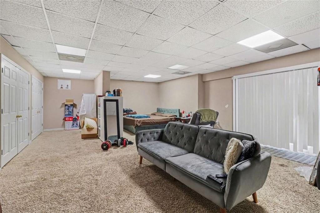 211 Stoney Point Cove Carrollton, GA 30116 - Photo 26 of 38 a living room with furniture and a gym machine