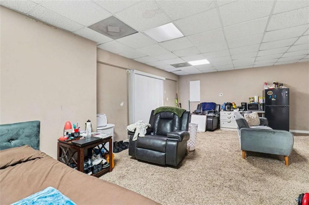211 Stoney Point Cove Carrollton, GA 30116 - Photo 28 of 38 a living room with furniture and a gym machine