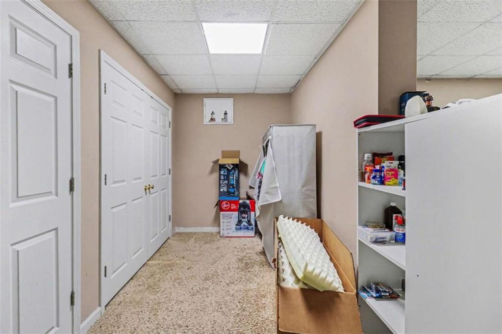 211 Stoney Point Cove Carrollton, GA 30116 - Photo 29 of 38 a living room with furniture and a wooden floor