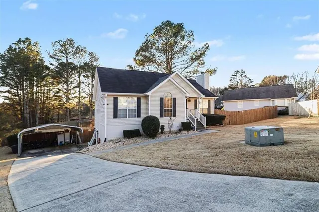 a front view of a house with cars parked