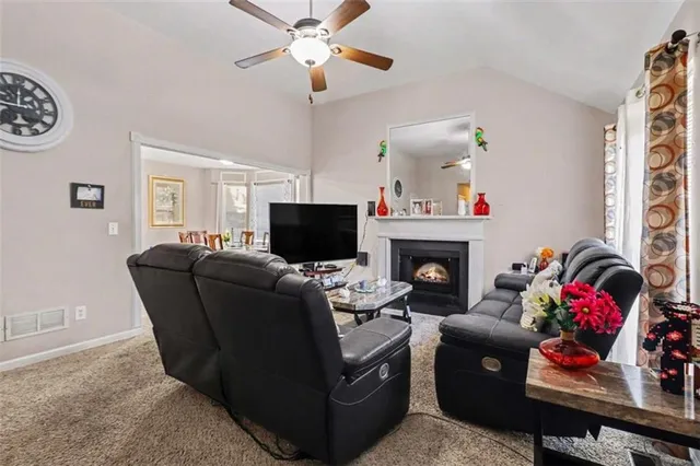 a living room with furniture a fireplace and a window