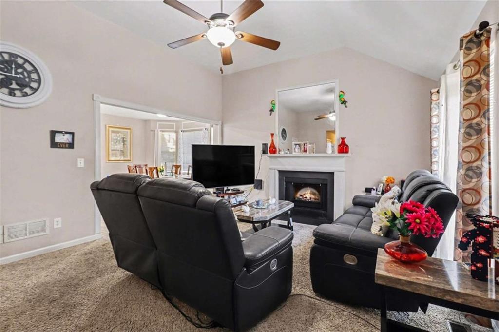 211 Stoney Point Cove Carrollton, GA 30116 - Photo 9 of 38 a living room with furniture a fireplace and a window