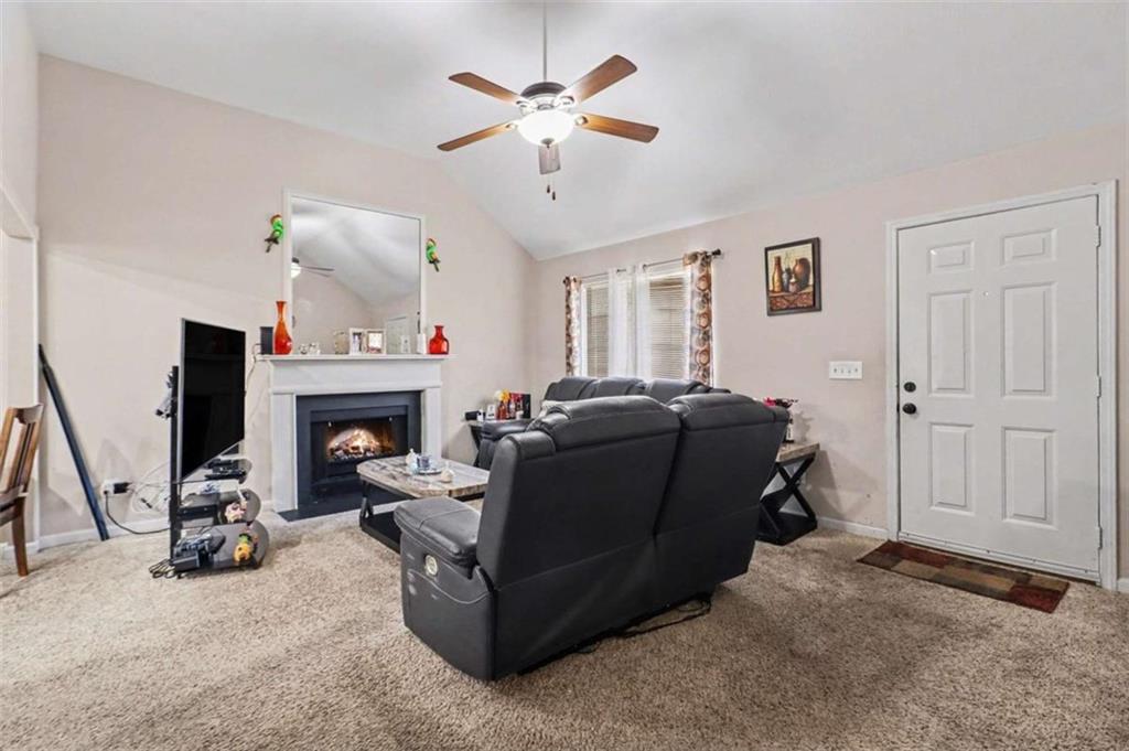 211 Stoney Point Cove Carrollton, GA 30116 - Photo 10 of 38 a living room with furniture and a fireplace