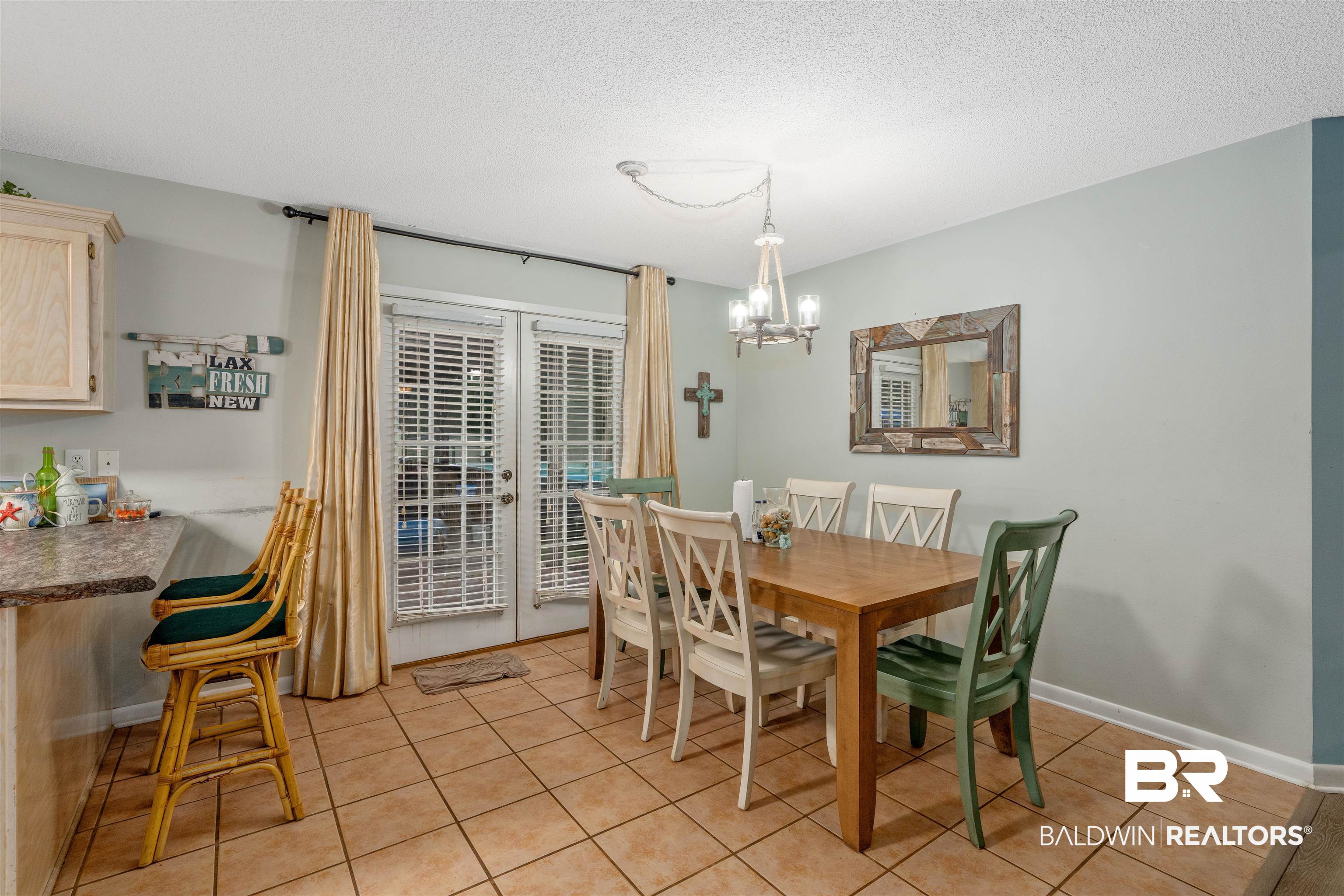 23186 Pecan Street Robertsdale, AL 36567 - Photo 7 of 36 Dining area featuring a textured ceiling, light tile patterned flooring, a chandelier, and french doors