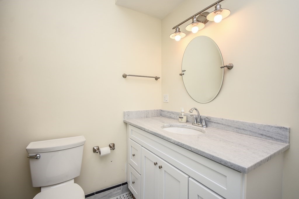 32 Cameron Street Everett, MA 02149 - Photo 13 of 22 a bathroom with a granite countertop sink a toilet and a mirror