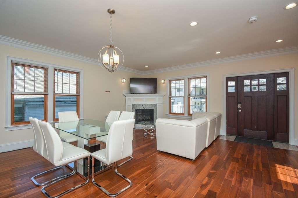 32 Cameron Street Everett, MA 02149 - Photo 5 of 22 a living room with furniture a fireplace and a chandelier
