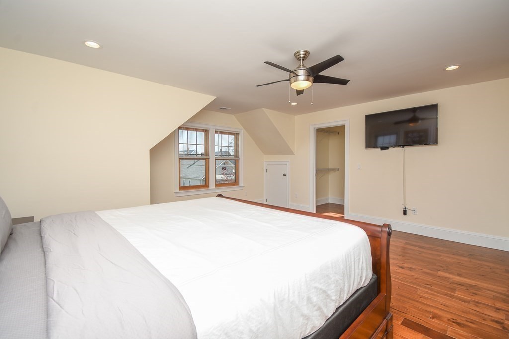 32 Cameron Street Everett, MA 02149 - Photo 7 of 22 a bedroom with a large bed and a flat screen tv