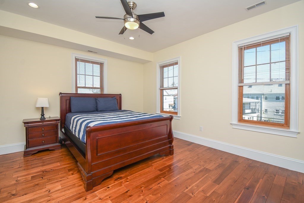 32 Cameron Street Everett, MA 02149 - Photo 8 of 22 a bedroom with a bed and wooden floor