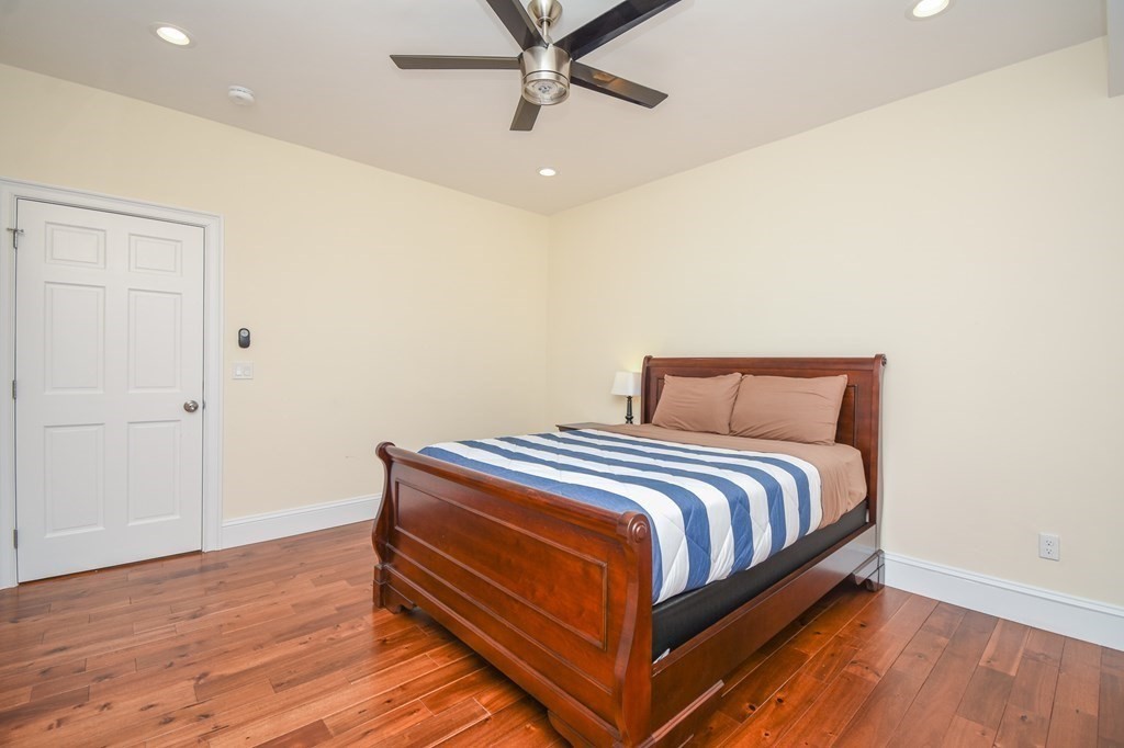 32 Cameron Street Everett, MA 02149 - Photo 9 of 22 a bedroom with a bed and wooden floor