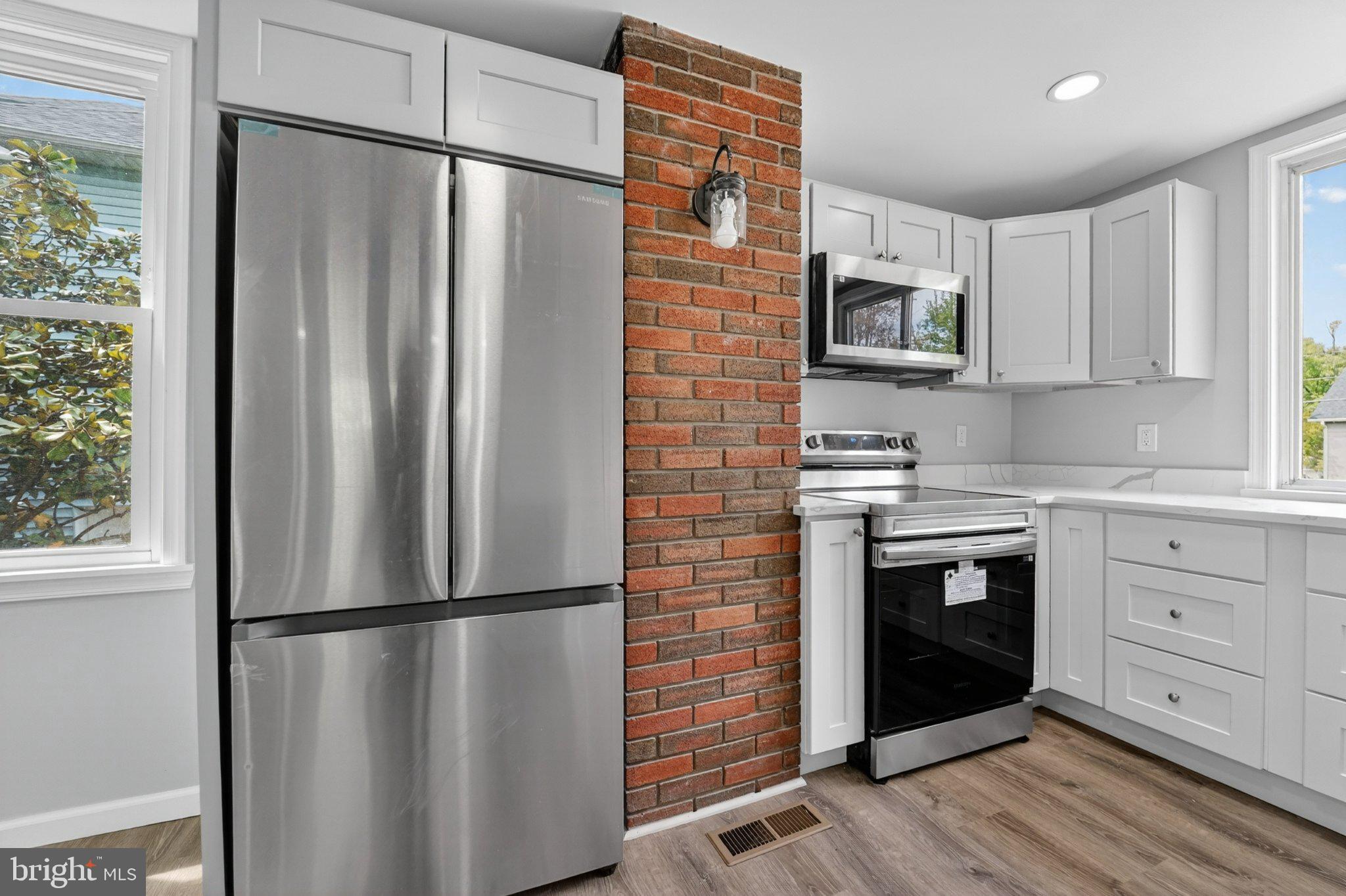 5312 Catalpha Road Baltimore, MD 21214 - Photo 37 of 59 a kitchen with stainless steel appliances a refrigerator sink and microwave