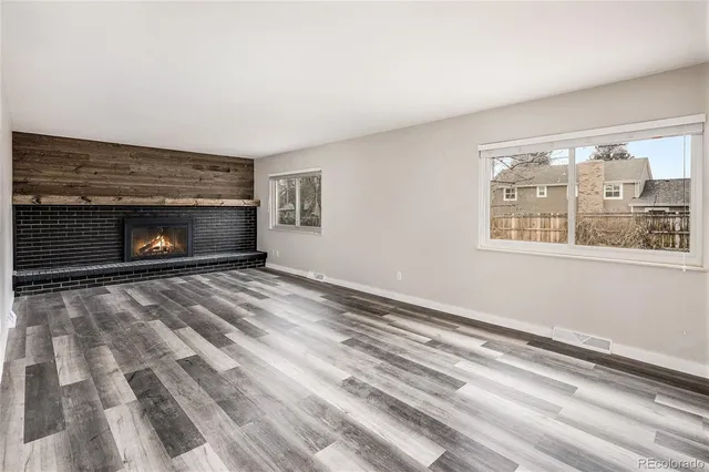 a view of empty room with window and fireplace