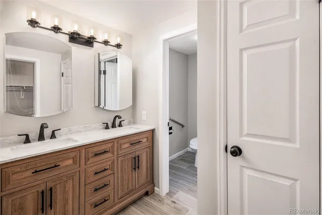 a bathroom with a double vanity sink mirror and