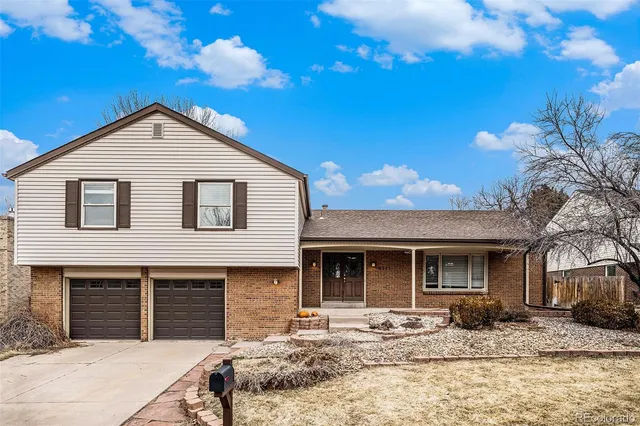a front view of a house with yard and seating area