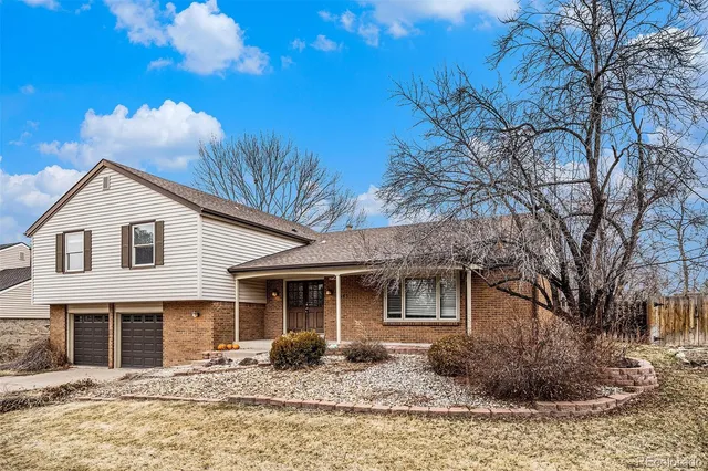 a front view of a house with yard covered in snow