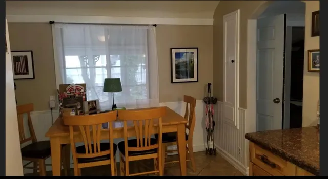 a view of a dining room with furniture and window