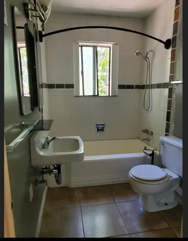 a white toilet sitting next to a bathroom sink