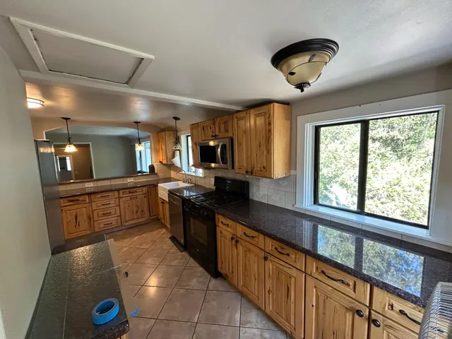 a large kitchen with stainless steel appliances a large counter space