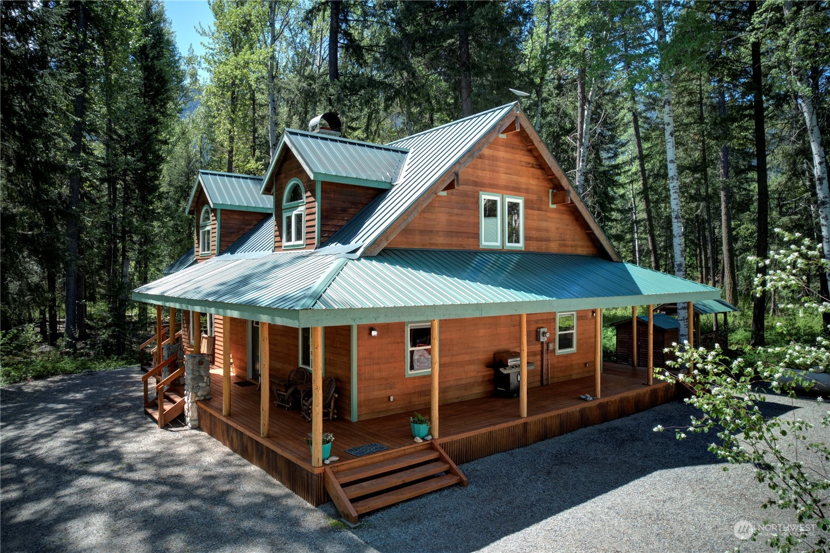 699 Lost River Road Mazama, WA 98833 - Photo 13 of 40 a view of a house with a yard balcony and wooden fence