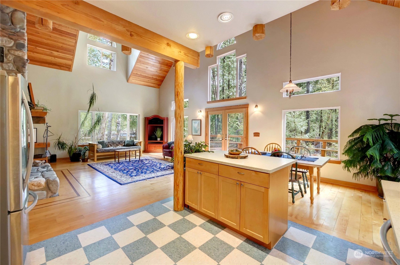 699 Lost River Road Mazama, WA 98833 - Photo 19 of 40 a open kitchen with stainless steel appliances granite countertop a stove top oven a dining table and chairs with wooden floor