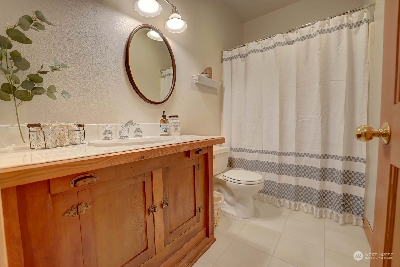 699 Lost River Road Mazama, WA 98833 - Photo 20 of 40 a bathroom with a toilet a sink a mirror and shower curtain