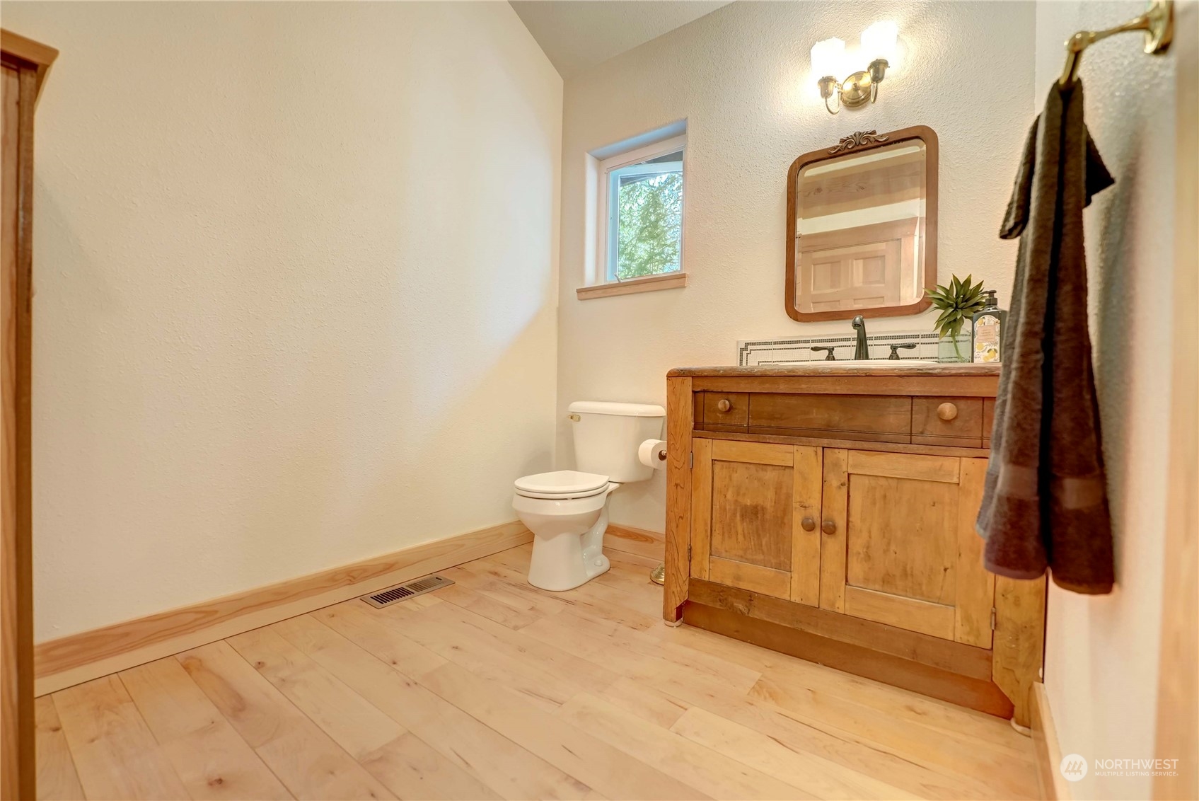 699 Lost River Road Mazama, WA 98833 - Photo 33 of 40 a bathroom with a granite countertop sink a toilet and a mirror