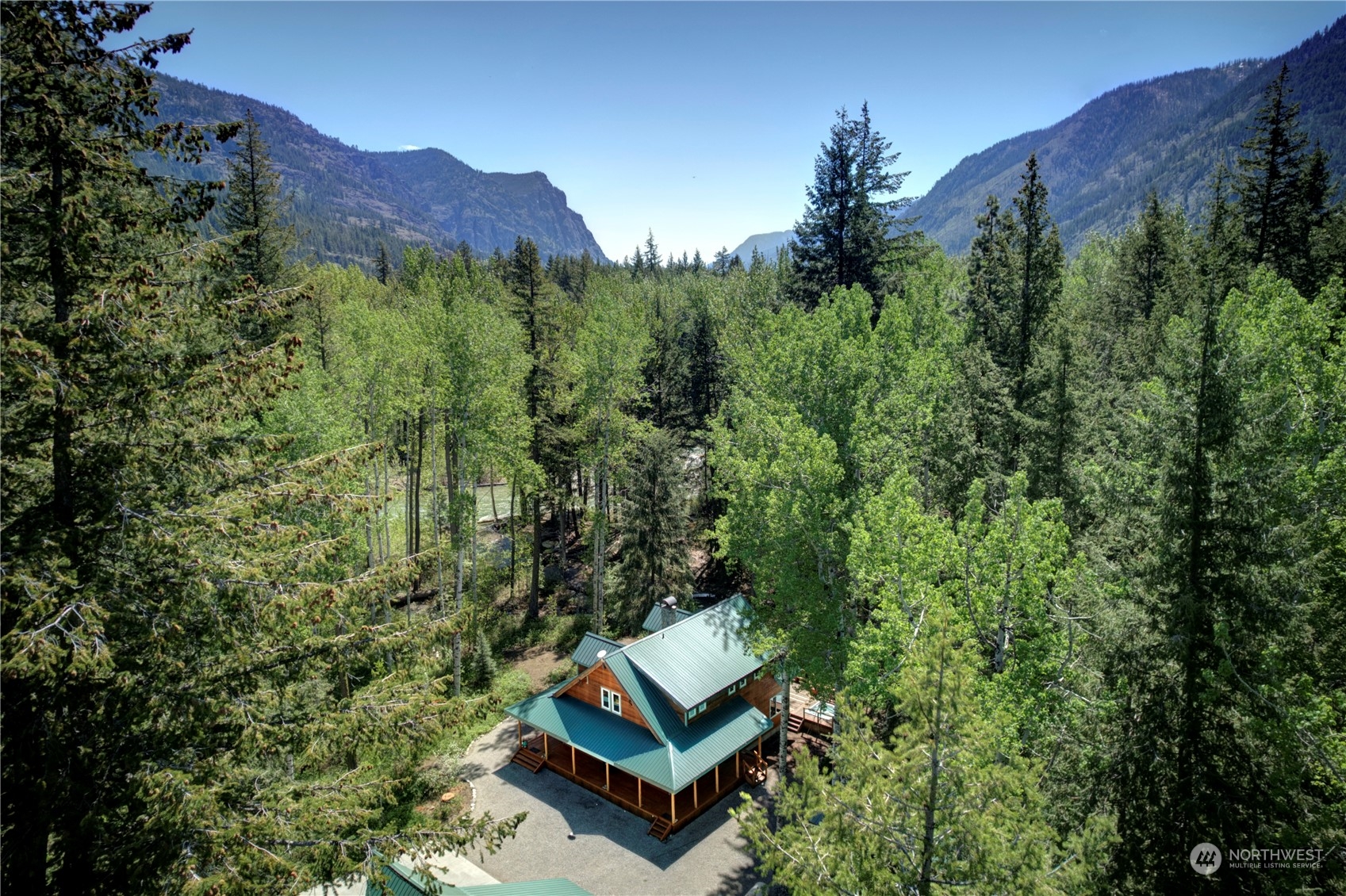 699 Lost River Road Mazama, WA 98833 - Photo 4 of 40 a view of a back yard from a bench