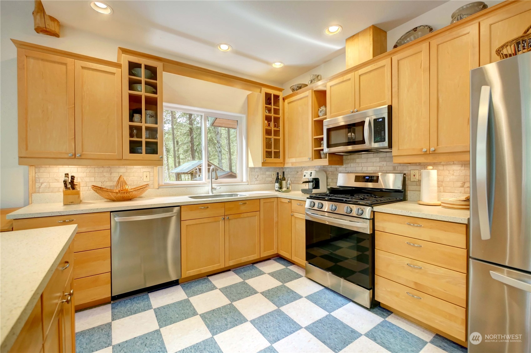 699 Lost River Road Mazama, WA 98833 - Photo 7 of 40 a kitchen with stainless steel appliances granite countertop a stove a sink and a microwave