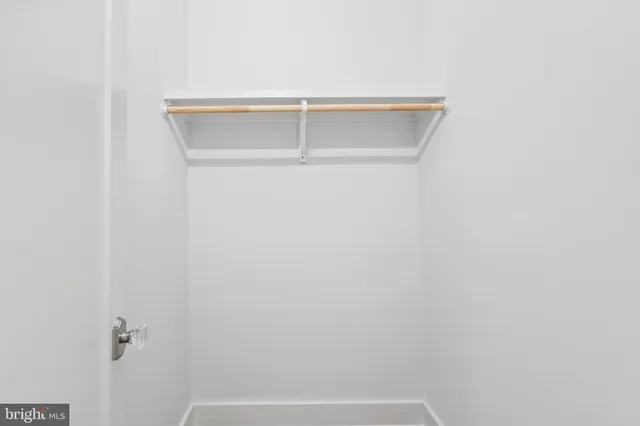 a bedroom with a bed and a potted plant