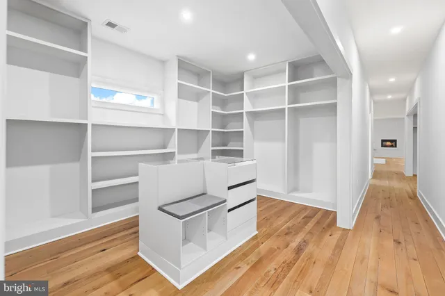 a view of a room with wooden floor and window