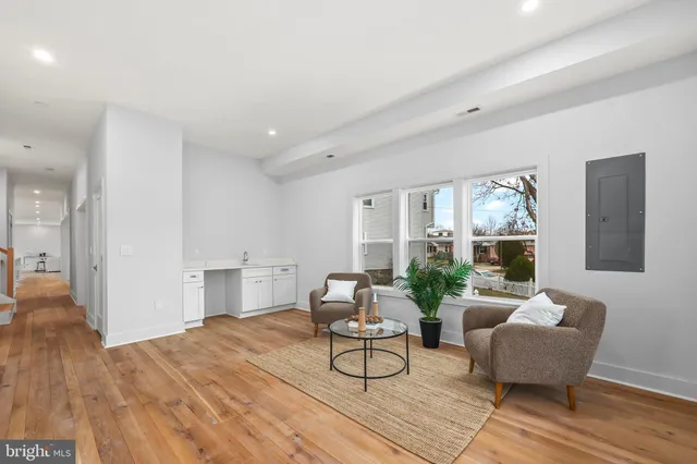 a view of a workspace with furniture and bookshelf