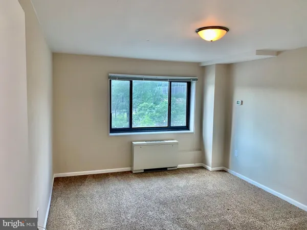 an empty room with a window and a table