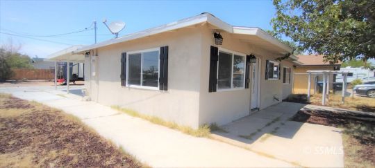 137 South Sunland Street Ridgecrest, CA 93555 - Photo 2 of 18 a front view of a house with a yard