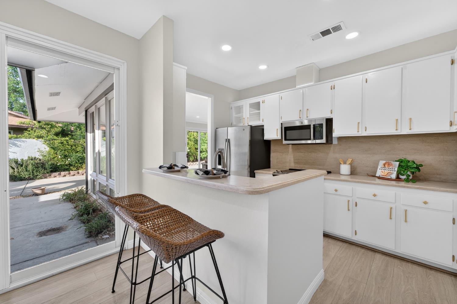 6035 Bryce Way Rocklin, CA 95677 - Photo 17 of 39 a kitchen with kitchen island granite countertop white cabinets and stainless steel appliances