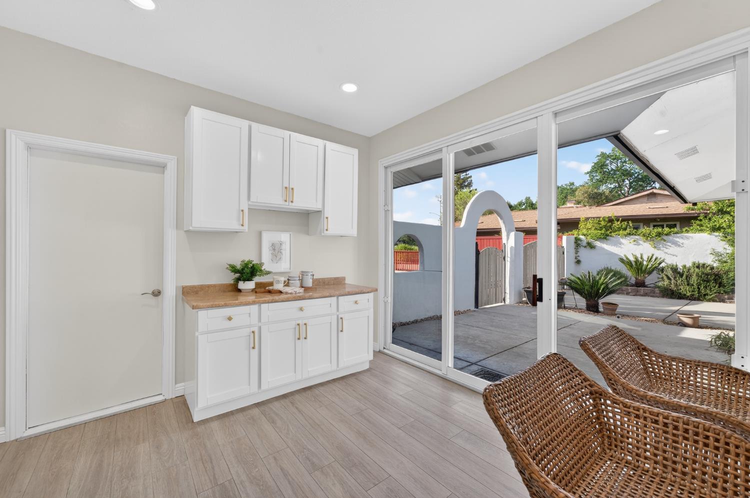 6035 Bryce Way Rocklin, CA 95677 - Photo 18 of 39 a kitchen with stainless steel appliances granite countertop a stove a sink and white cabinets with wooden floor