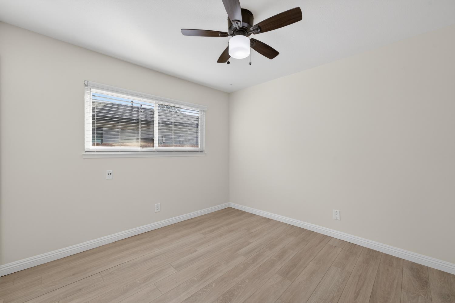 6035 Bryce Way Rocklin, CA 95677 - Photo 20 of 39 an empty room with wooden floor fan and windows