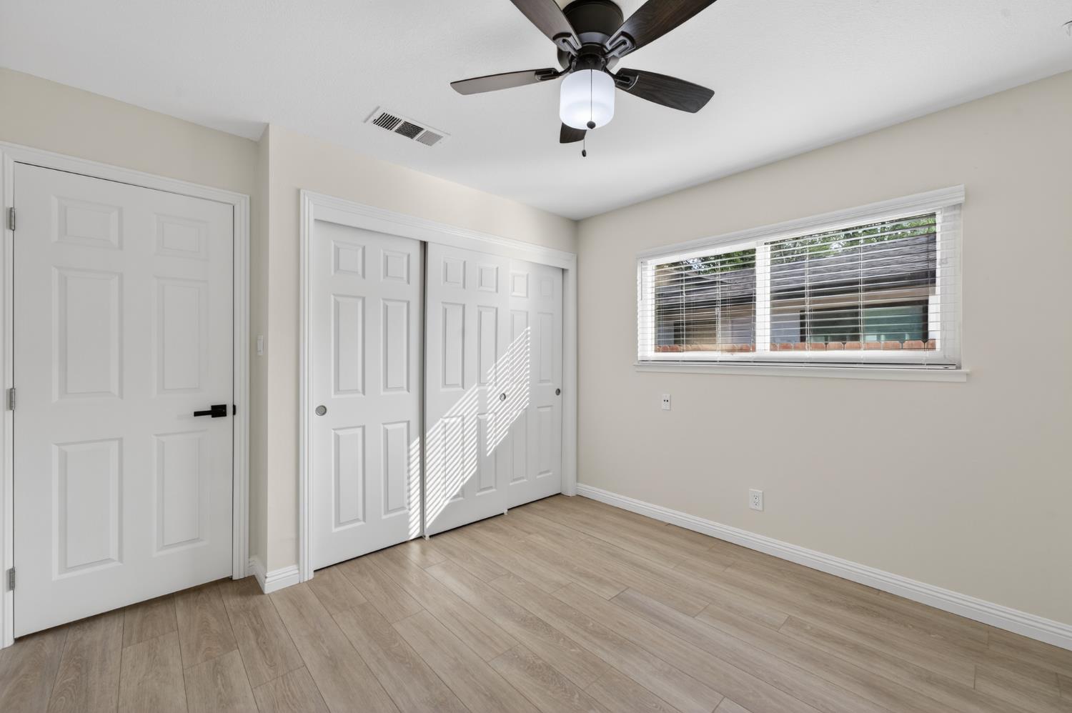 6035 Bryce Way Rocklin, CA 95677 - Photo 21 of 39 a view of an empty room with wooden floor and a window