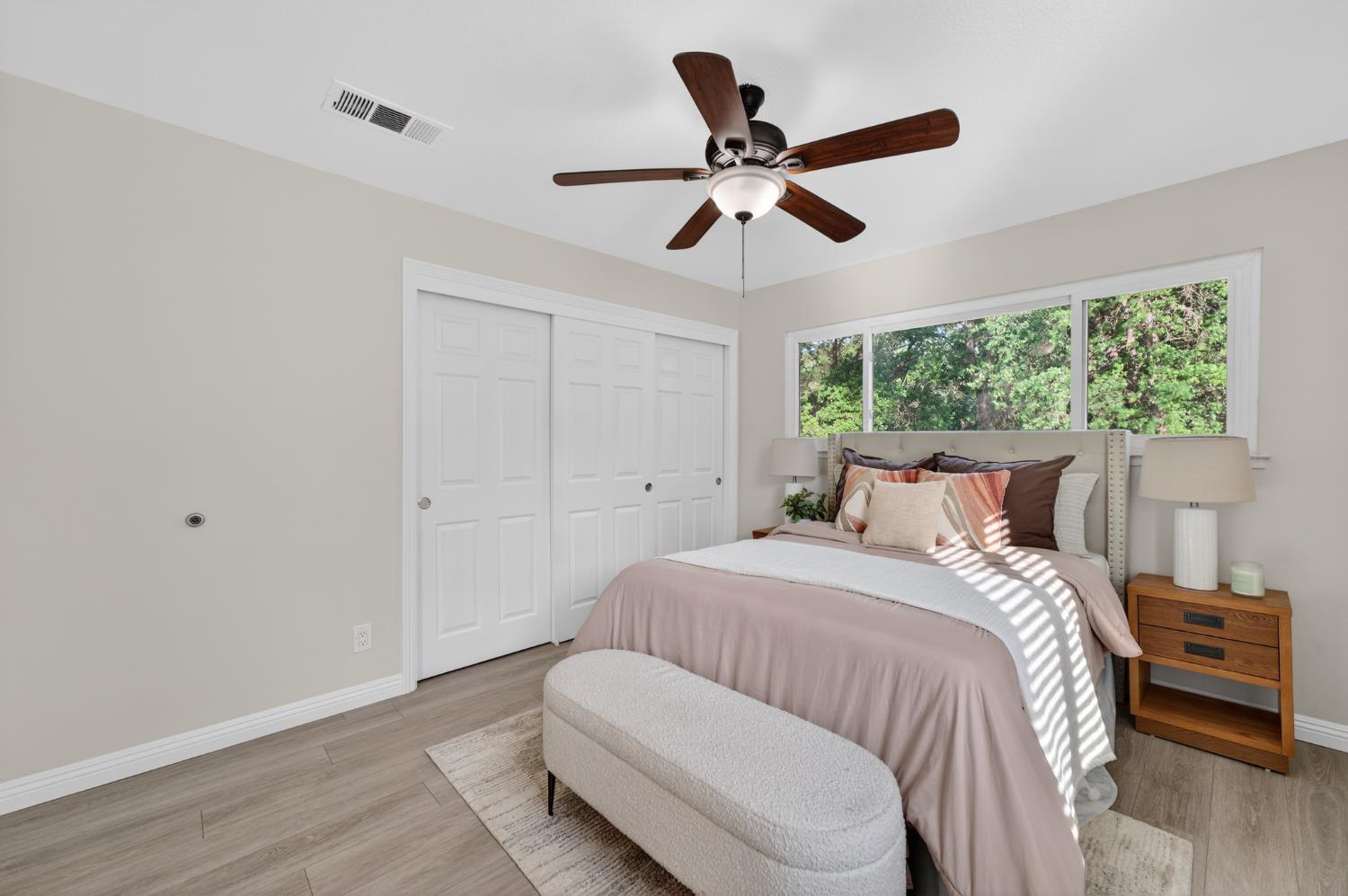 6035 Bryce Way Rocklin, CA 95677 - Photo 25 of 39 a bedroom with a large bed and a chandelier