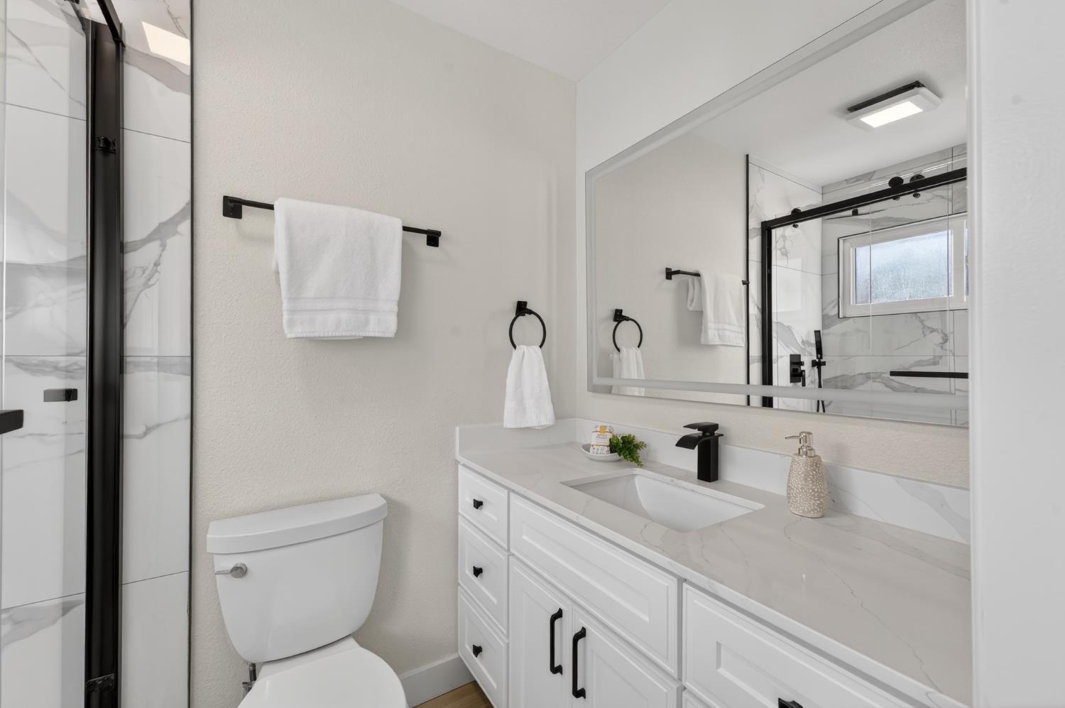 6035 Bryce Way Rocklin, CA 95677 - Photo 26 of 39 a bathroom with a toilet sink and mirror
