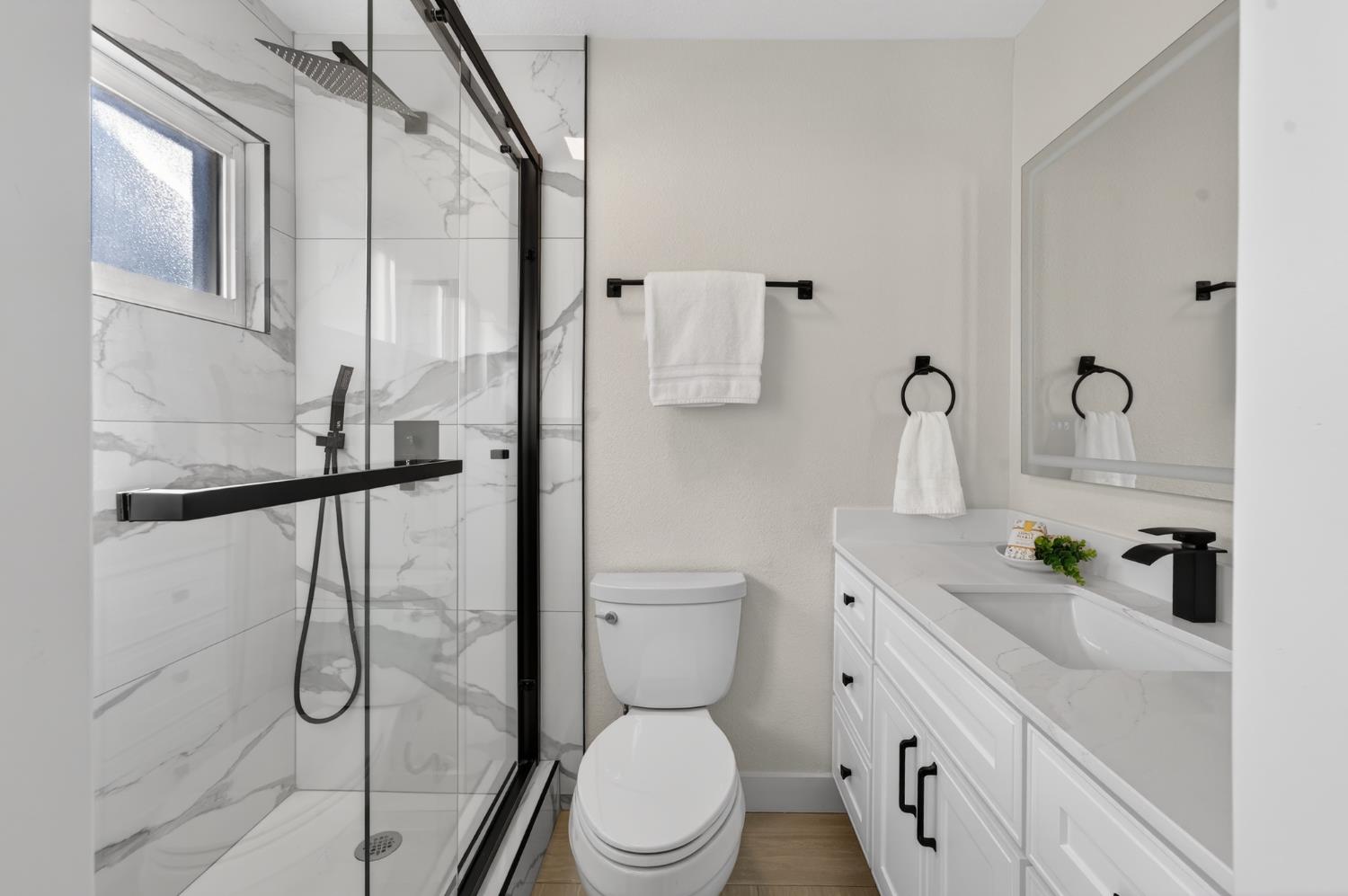 6035 Bryce Way Rocklin, CA 95677 - Photo 27 of 39 a white toilet sitting next to a bathroom sink