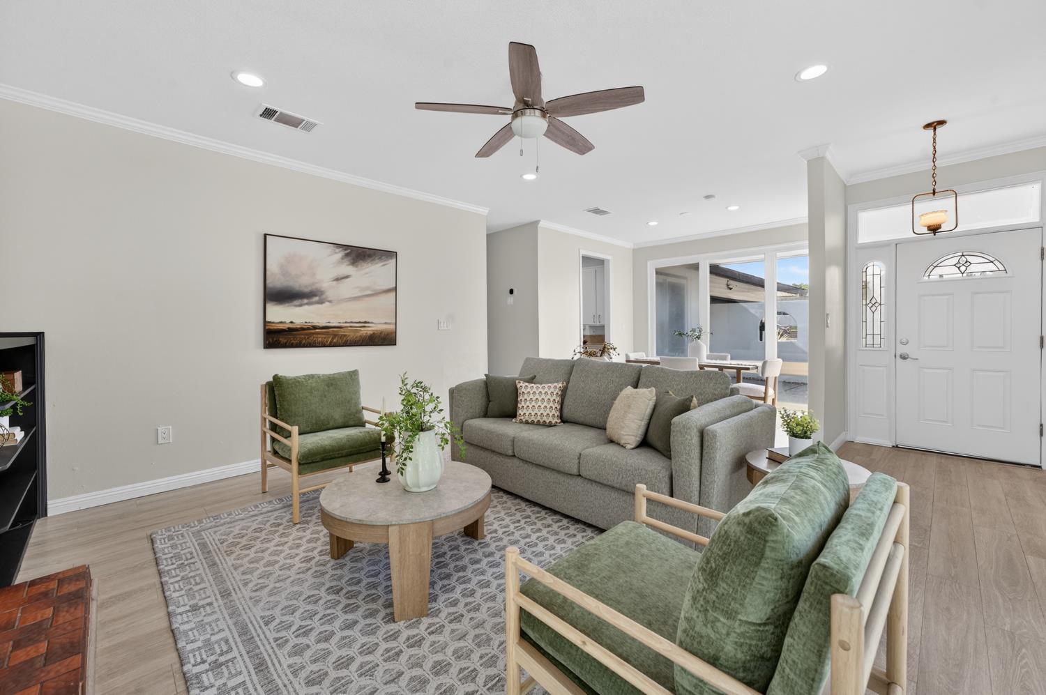 6035 Bryce Way Rocklin, CA 95677 - Photo 9 of 39 a living room with furniture a rug and a chandelier