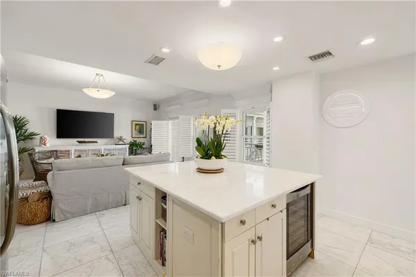 a view of kitchen with sink microwave and refrigerator