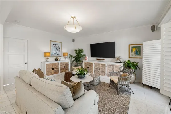 a living room with furniture and view of kitchen