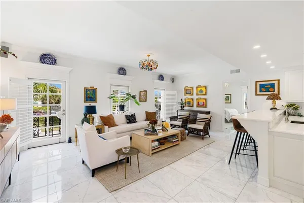 a living room with furniture kitchen view and a table