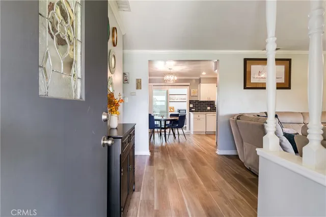 a dining room with furniture and wooden floor