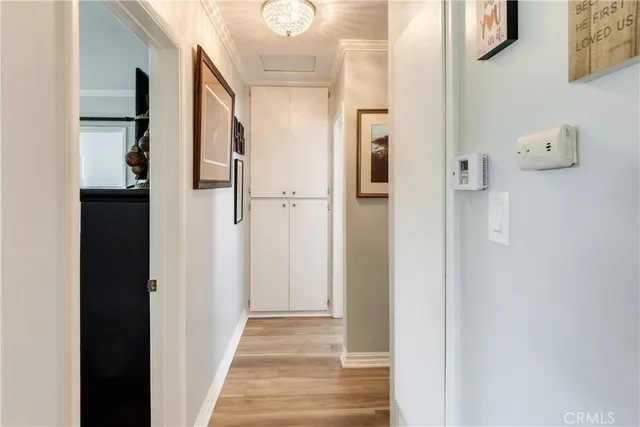a view of a hallway with wooden floor and entryway