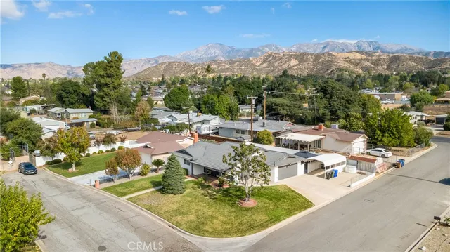 a view of a swimming pool with a patio and a yard