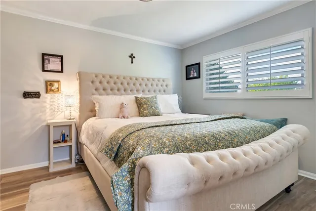 a bed sitting in a bedroom next to a window