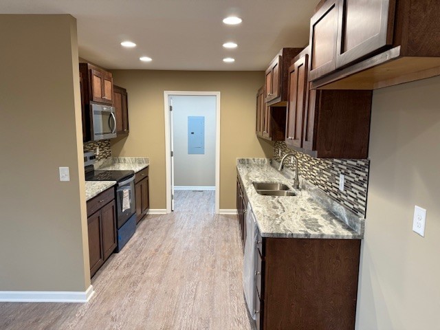 1427 Old Estill Springs Road Tullahoma, TN 37388 - Photo 11 of 44 a kitchen with stainless steel appliances granite countertop a sink stove and refrigerator