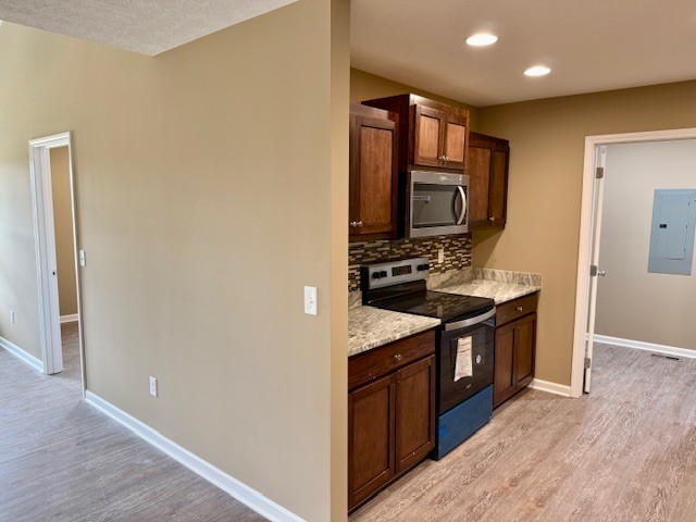 1427 Old Estill Springs Road Tullahoma, TN 37388 - Photo 13 of 44 a kitchen with stainless steel appliances granite countertop a stove and a microwave